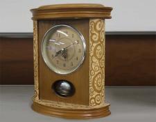 131    Battery clock in a hand carved wooden case    $30