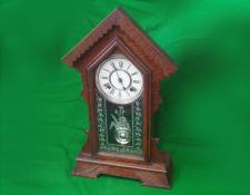 46    Ansonia Clock. American Sessions movement. Gable top Case with original patterned door glass. Has been serviced and is in working condition.       $195